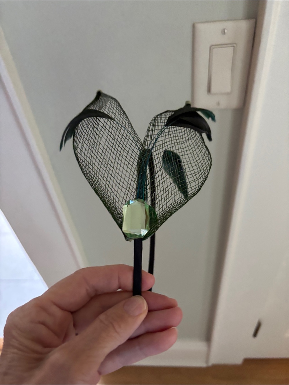 Head band with Green Mesh, green jewel and feathers.
